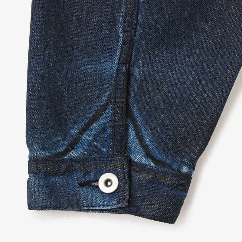 Boxy denim jacket with vintage wash, workwear details, and relaxed fit, styled with cargo pants.