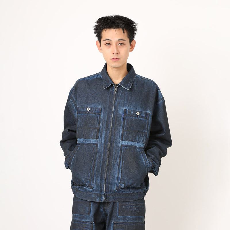 Boxy denim jacket with vintage wash, workwear details, and relaxed fit, styled with cargo pants.