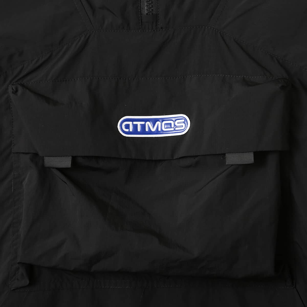 Lightweight, water-repellent anorak jacket with zippered back panel for wearing over a backpack