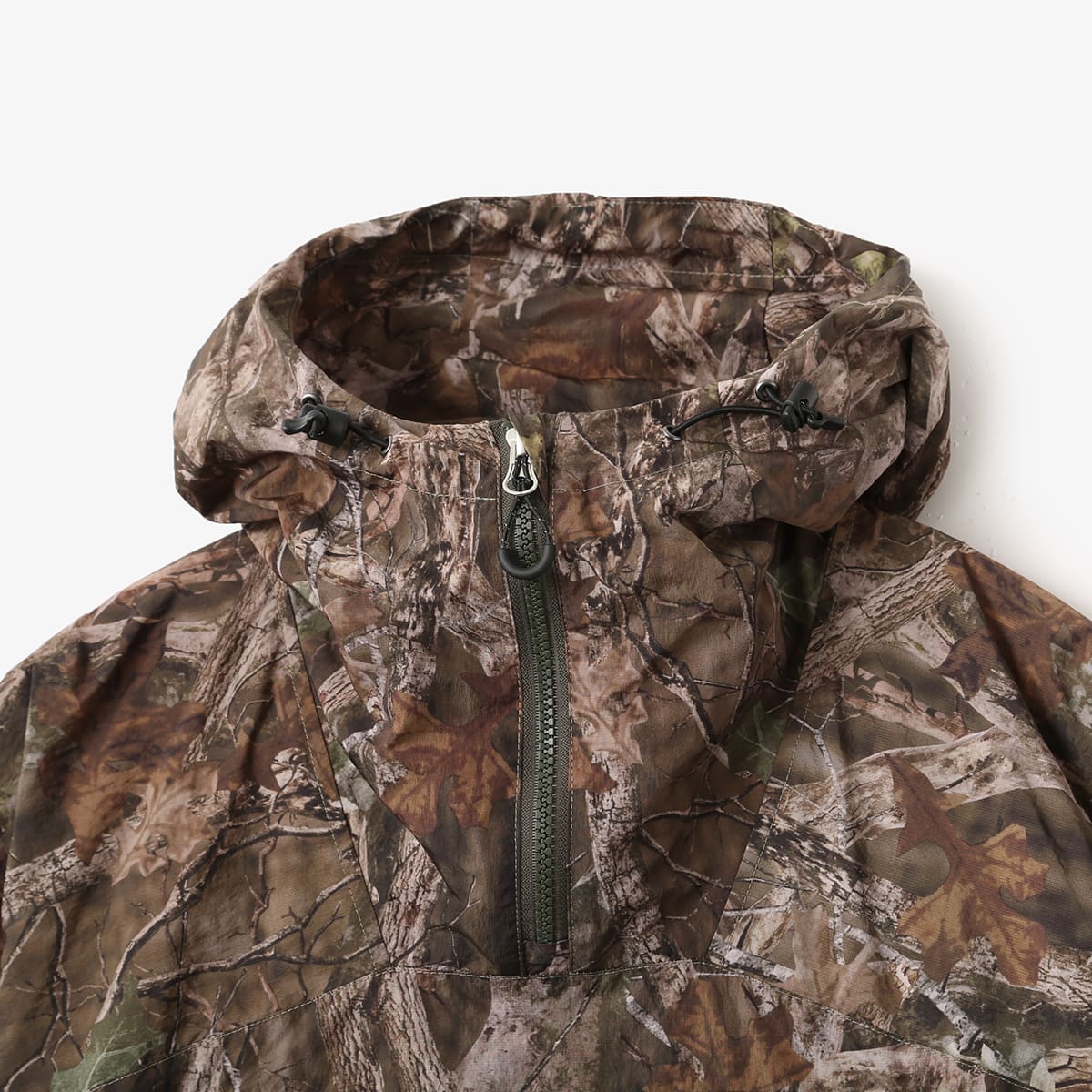 Lightweight, water-repellent anorak jacket with zippered back panel for wearing over a backpack
