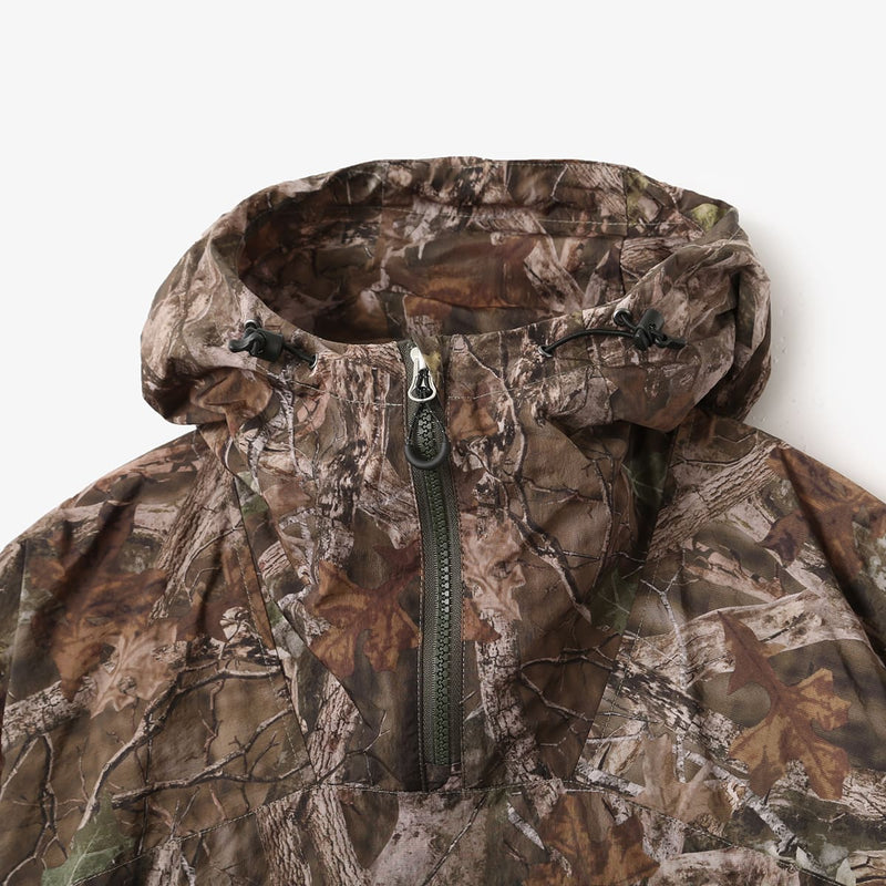 Lightweight, water-repellent anorak jacket with zippered back panel for wearing over a backpack