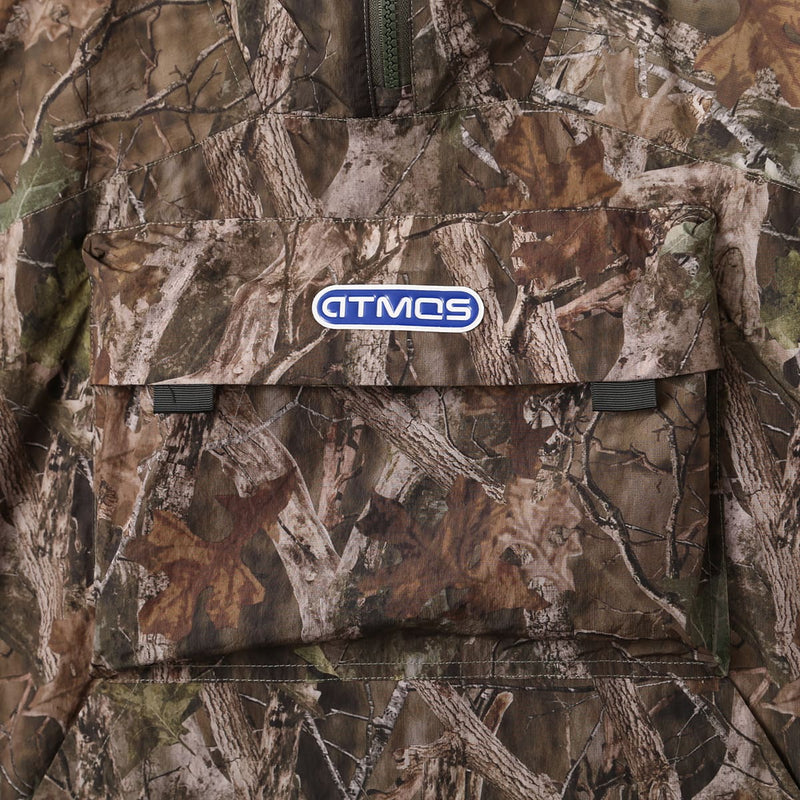 Lightweight, water-repellent anorak jacket with zippered back panel for wearing over a backpack