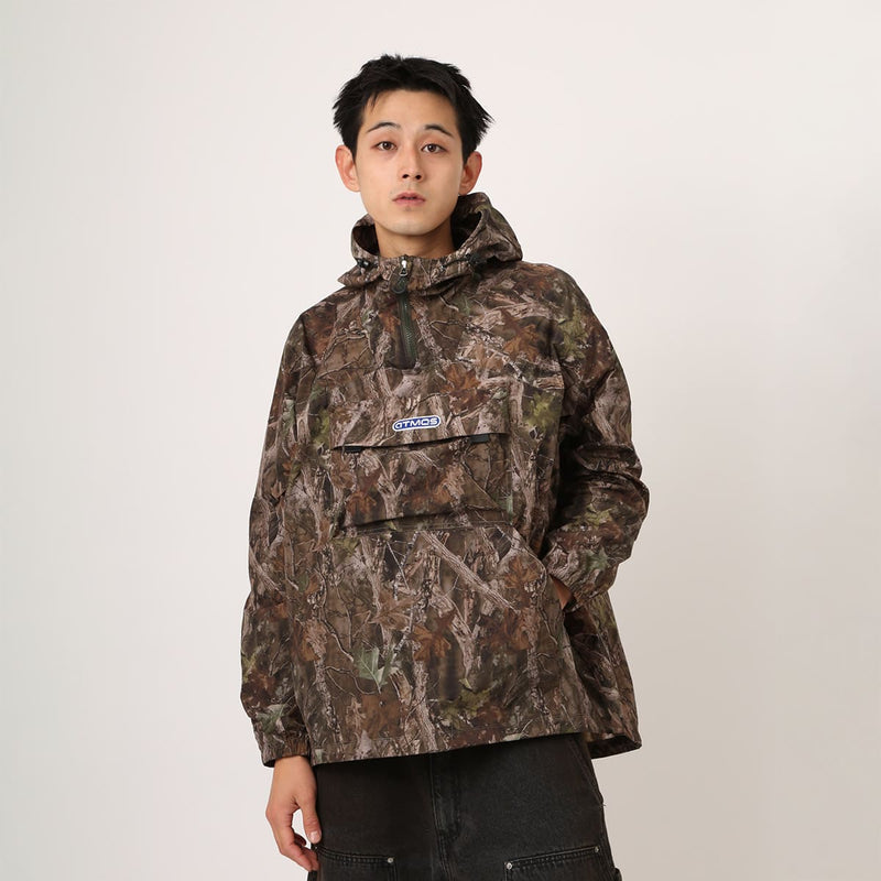 Lightweight, water-repellent anorak jacket with zippered back panel for wearing over a backpack
