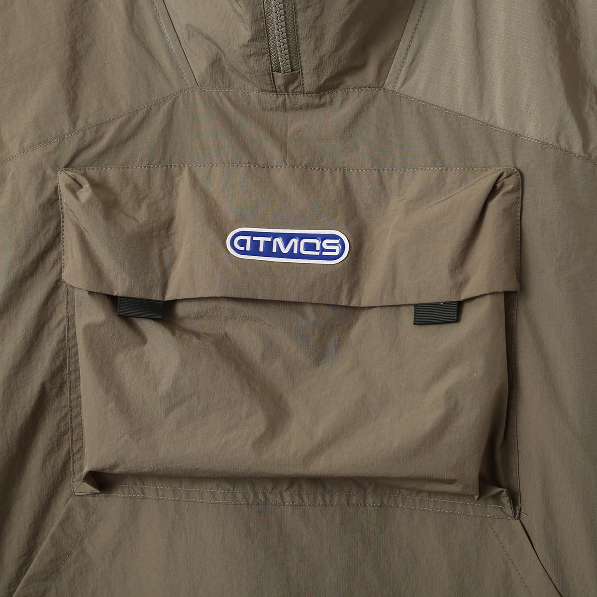 Lightweight, water-repellent anorak jacket with zippered back panel for wearing over a backpack