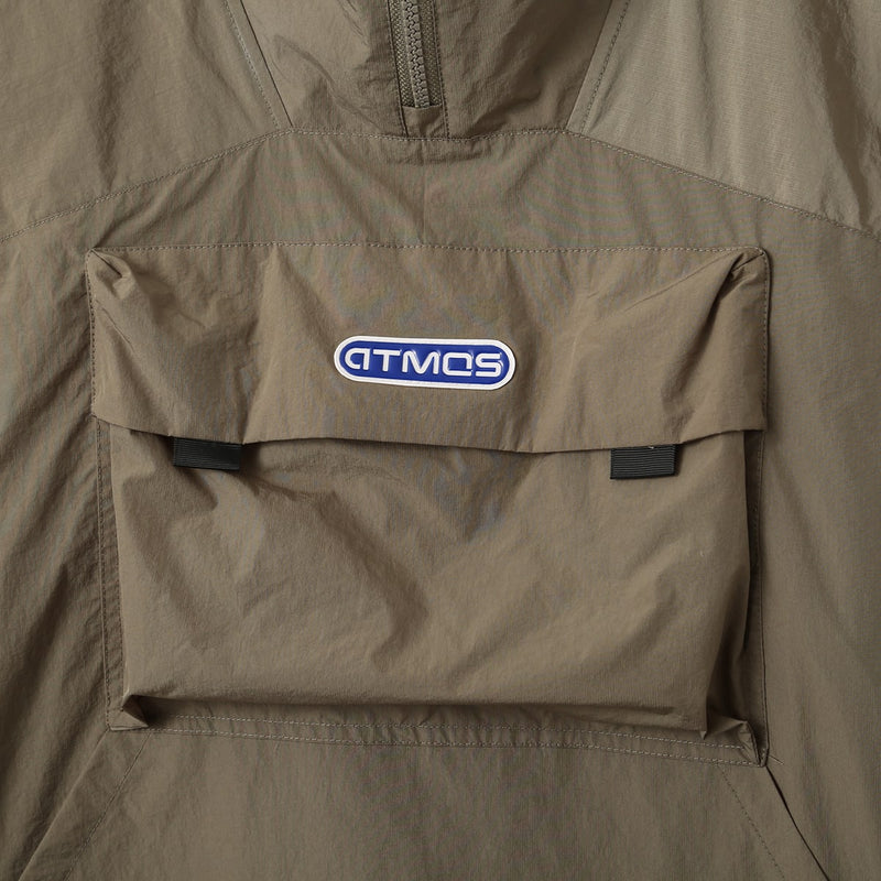 Lightweight, water-repellent anorak jacket with zippered back panel for wearing over a backpack