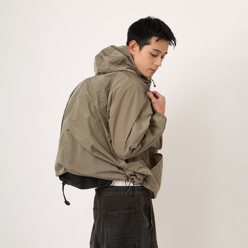 Lightweight, water-repellent anorak jacket with zippered back panel for wearing over a backpack