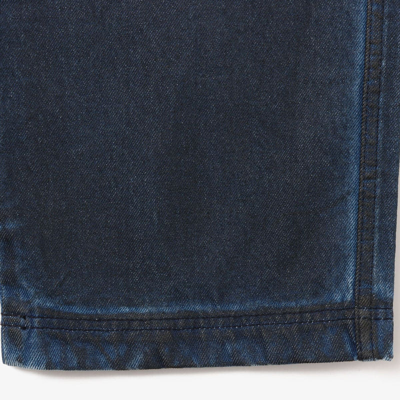 Vintage wash denim work pants with GI buckle waist, styled with matching denim jacket.
