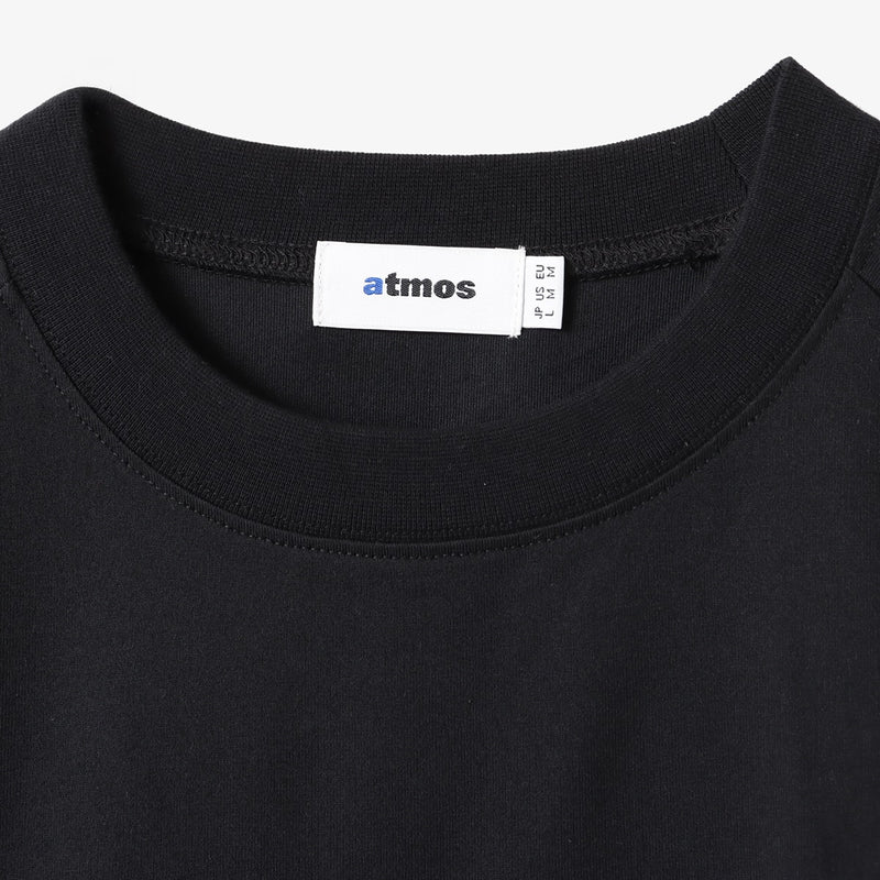 Sporty long-sleeve polyester T-shirt with raglan sleeves, reflective atmos logo on back neck, worn by 180cm model in size L