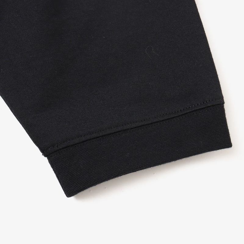 Sporty long-sleeve polyester T-shirt with raglan sleeves, reflective atmos logo on back neck, worn by 180cm model in size L