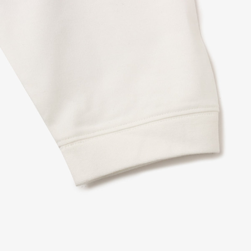 Sporty long-sleeve polyester T-shirt with raglan sleeves, reflective atmos logo on back neck, worn by 180cm model in size L