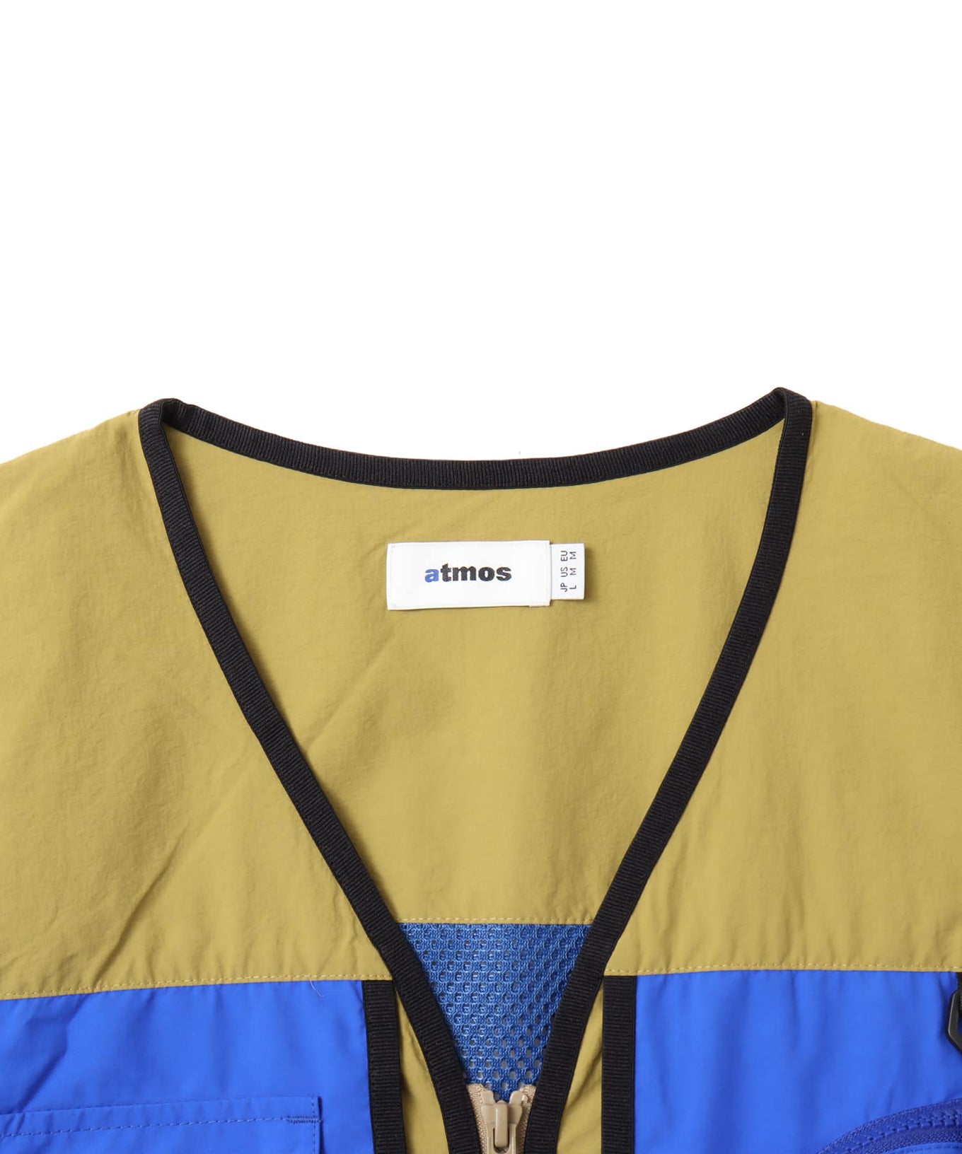 Model wearing a multi-pocket fishing-style vest made from textured nylon with a cotton-like finish.