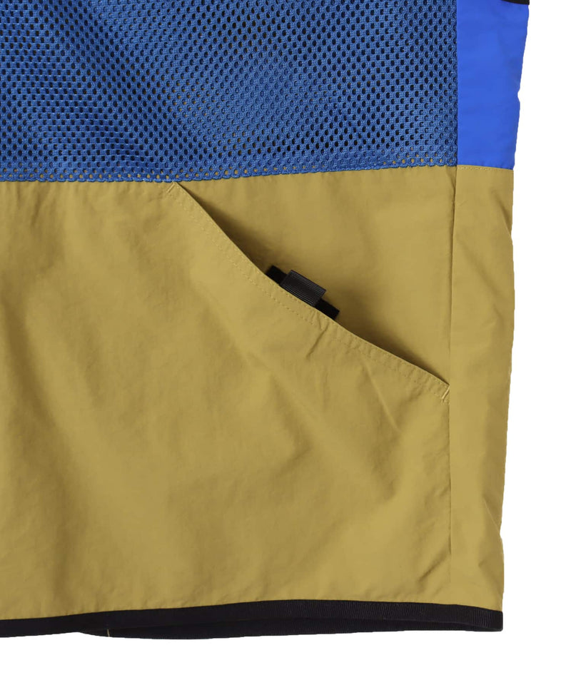 Model wearing a multi-pocket fishing-style vest made from textured nylon with a cotton-like finish.