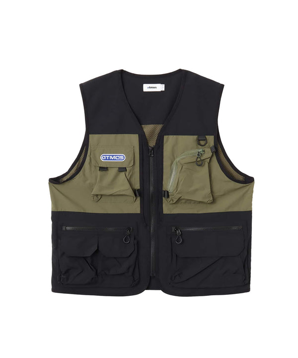 Model wearing a multi-pocket fishing-style vest made from textured nylon with a cotton-like finish.