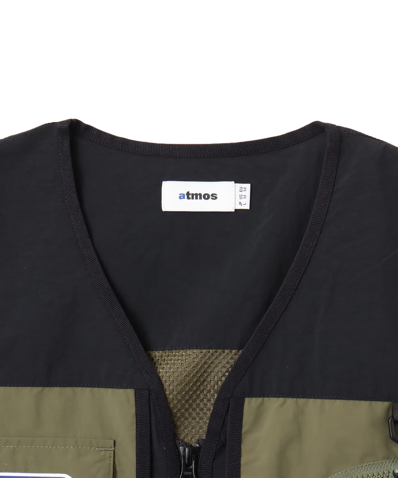 Model wearing a multi-pocket fishing-style vest made from textured nylon with a cotton-like finish.