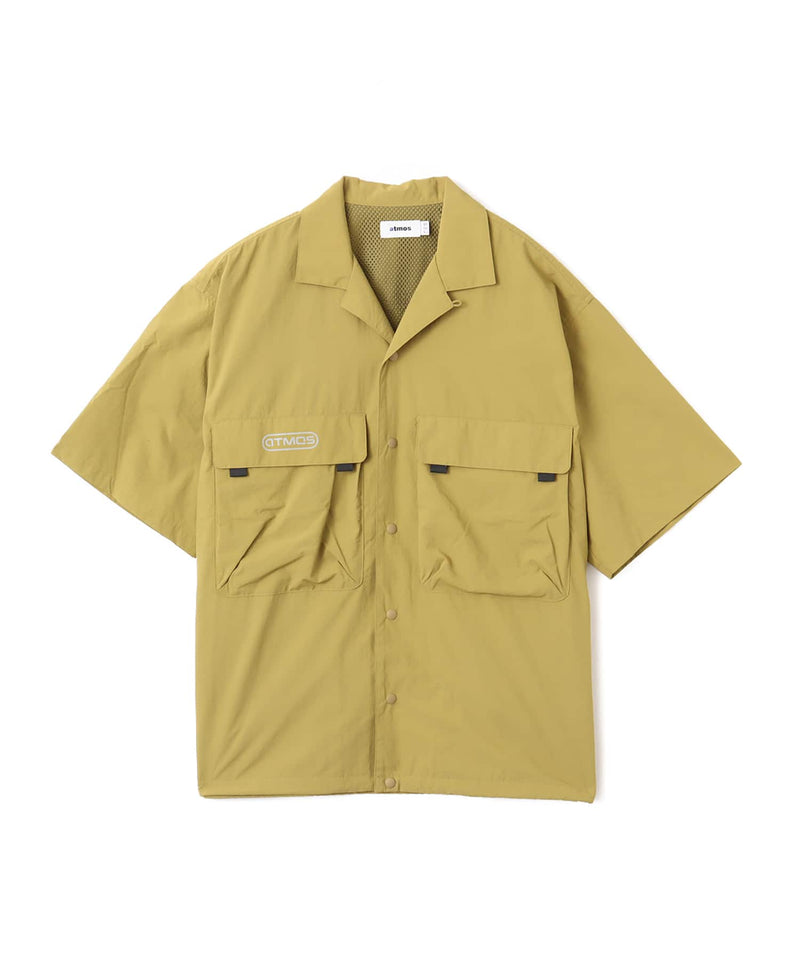 Model wearing a short-sleeved fishing-style nylon shirt with flap pocket and reflective atmos logo.
