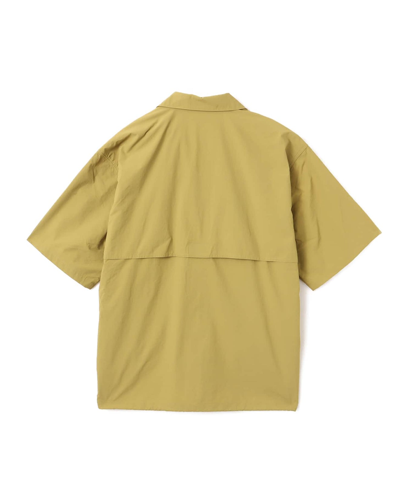 Model wearing a short-sleeved fishing-style nylon shirt with flap pocket and reflective atmos logo.