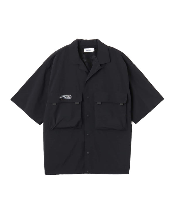 Model wearing a short-sleeved fishing-style nylon shirt with flap pocket and reflective atmos logo.