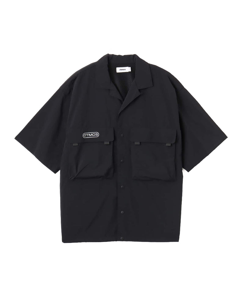 Model wearing a short-sleeved fishing-style nylon shirt with flap pocket and reflective atmos logo.