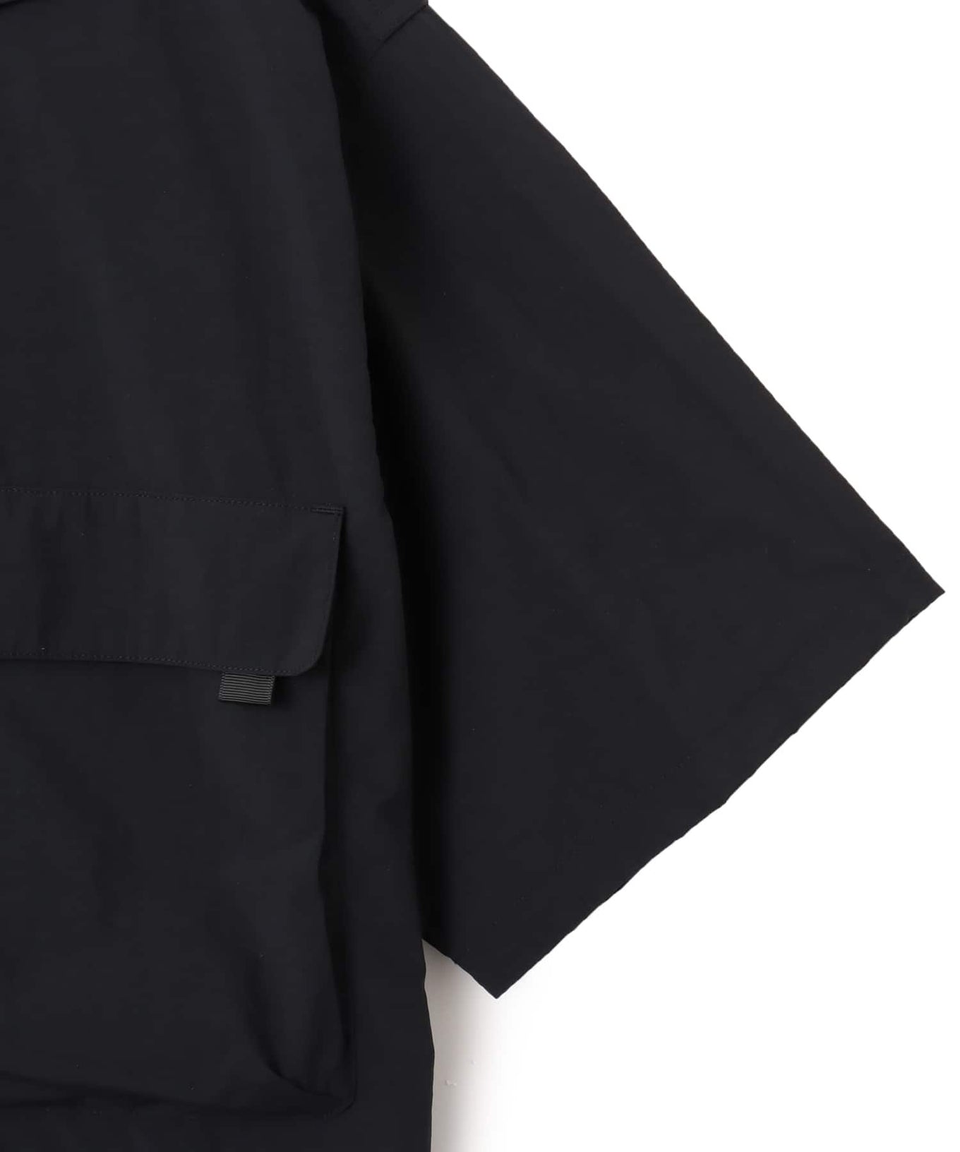 Model wearing a short-sleeved fishing-style nylon shirt with flap pocket and reflective atmos logo.