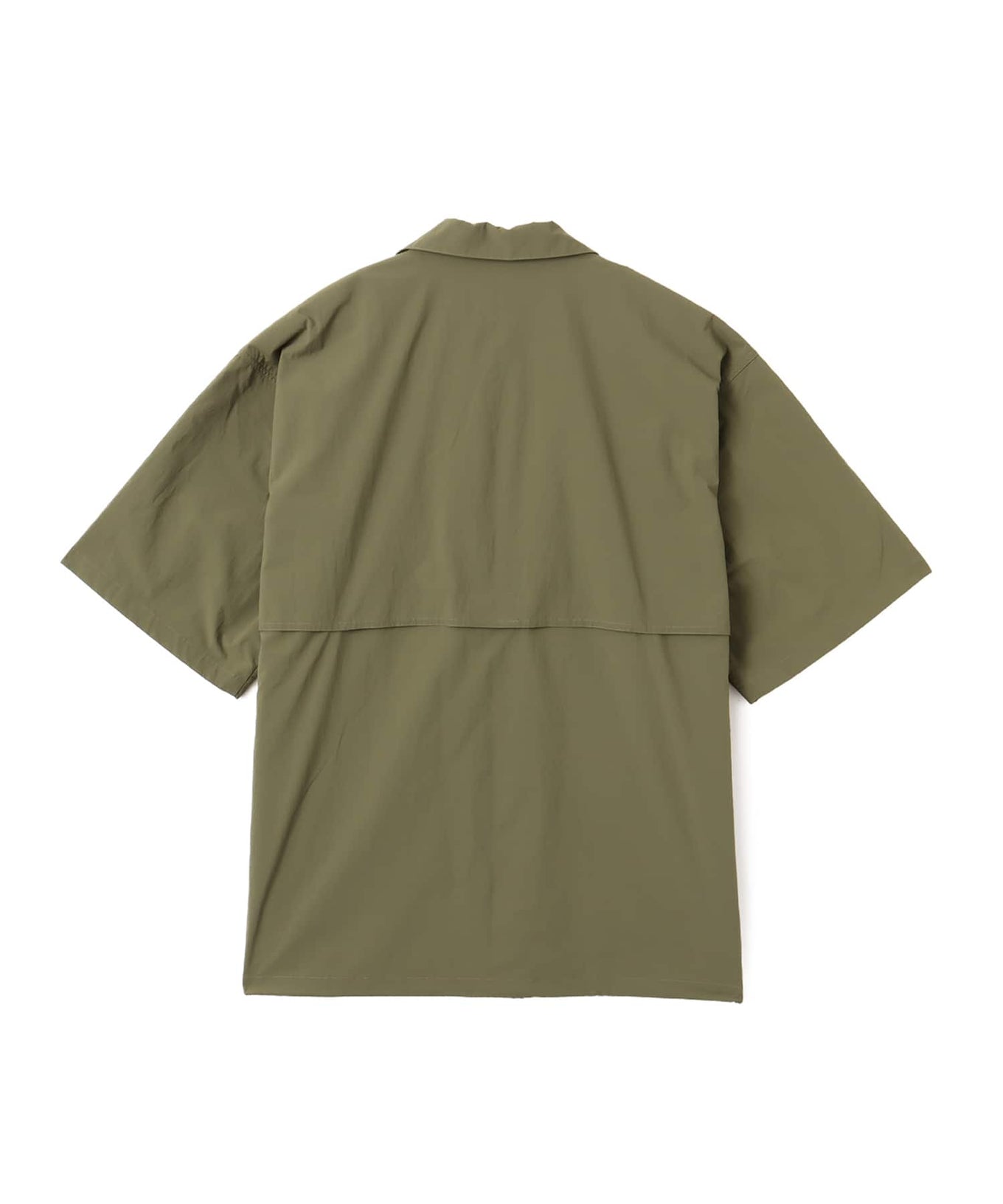 Model wearing a short-sleeved fishing-style nylon shirt with flap pocket and reflective atmos logo.