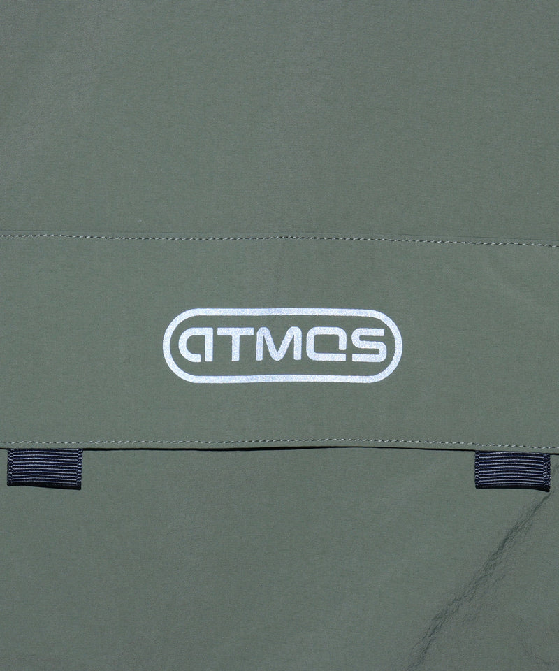 Model wearing a short-sleeved fishing-style nylon shirt with flap pocket and reflective atmos logo.