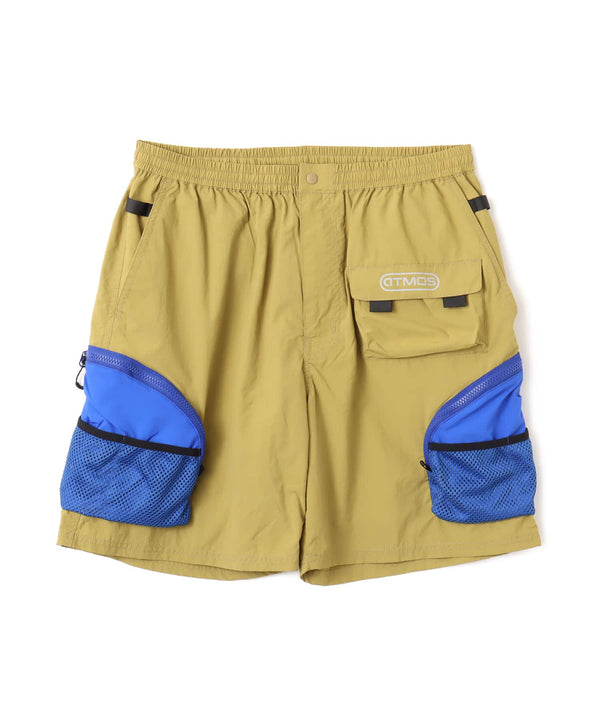 Model wearing functional cargo shorts with mesh and flap pockets in durable cotton fabric.