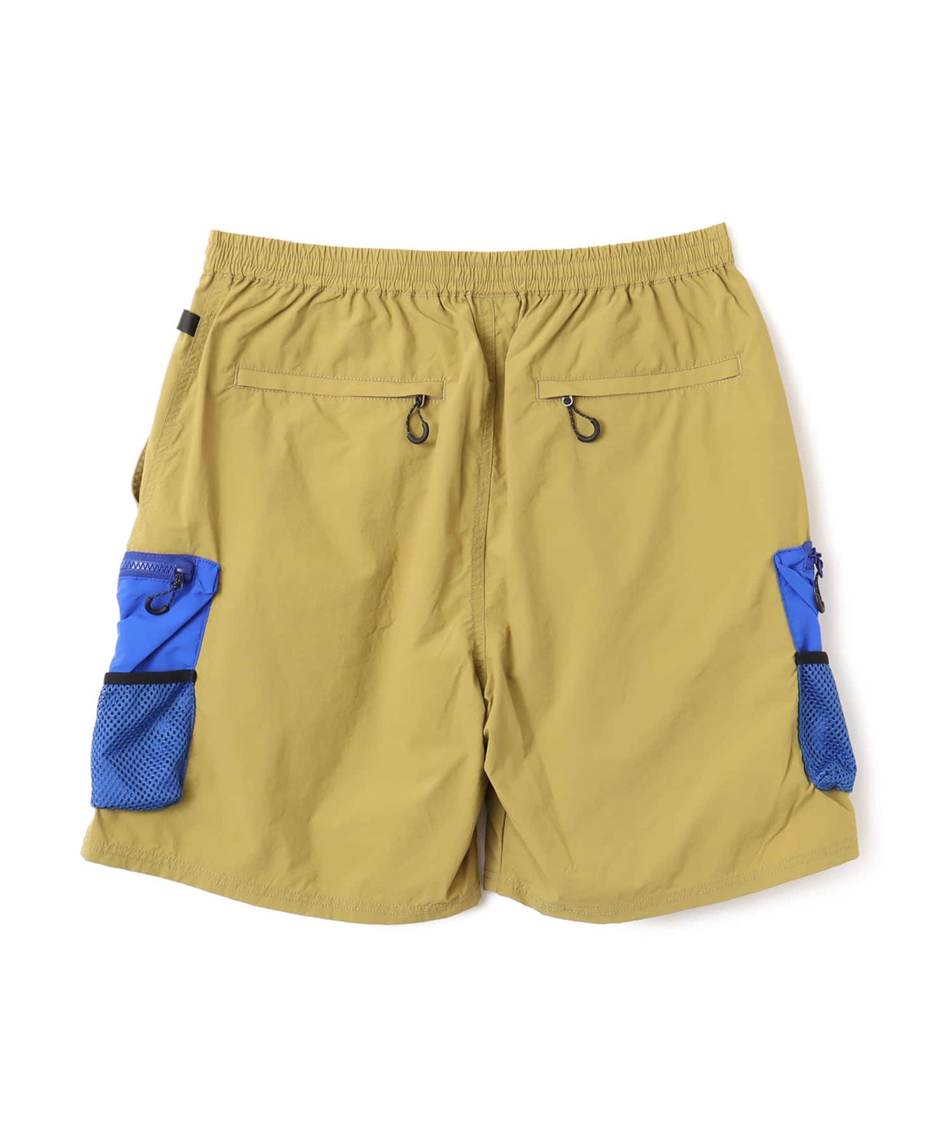 Model wearing functional cargo shorts with mesh and flap pockets in durable cotton fabric.