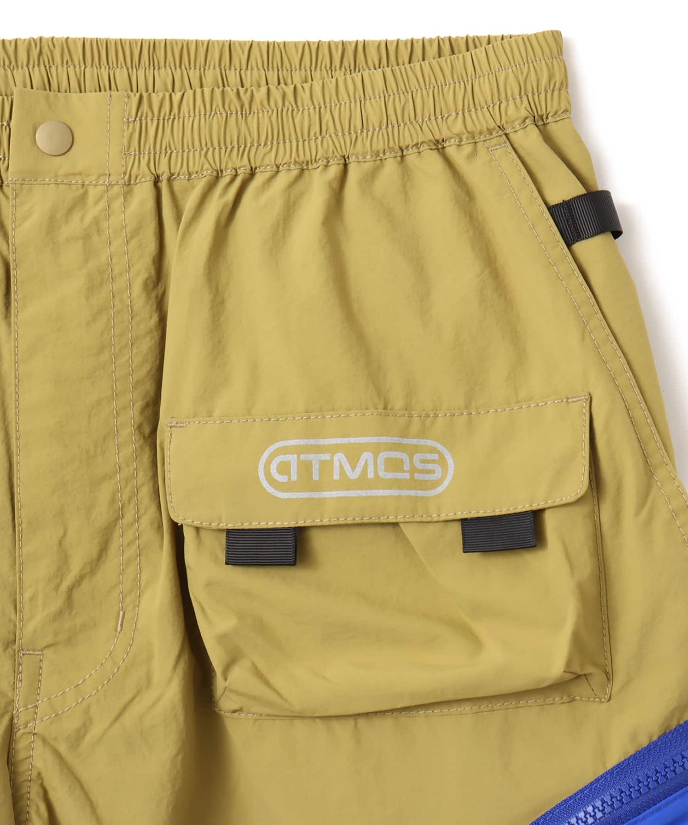Model wearing functional cargo shorts with mesh and flap pockets in durable cotton fabric.