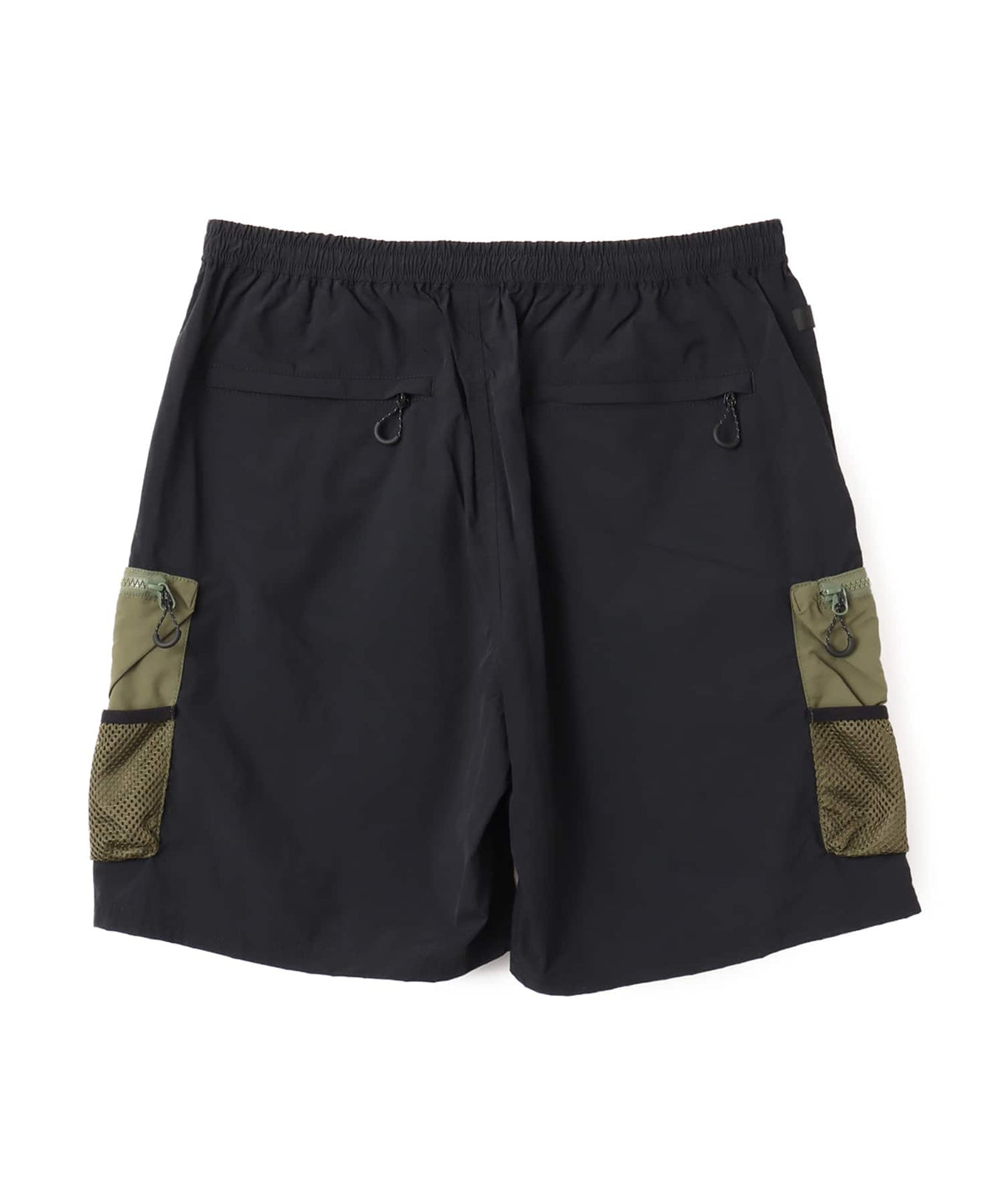 Model wearing functional cargo shorts with mesh and flap pockets in durable cotton fabric.