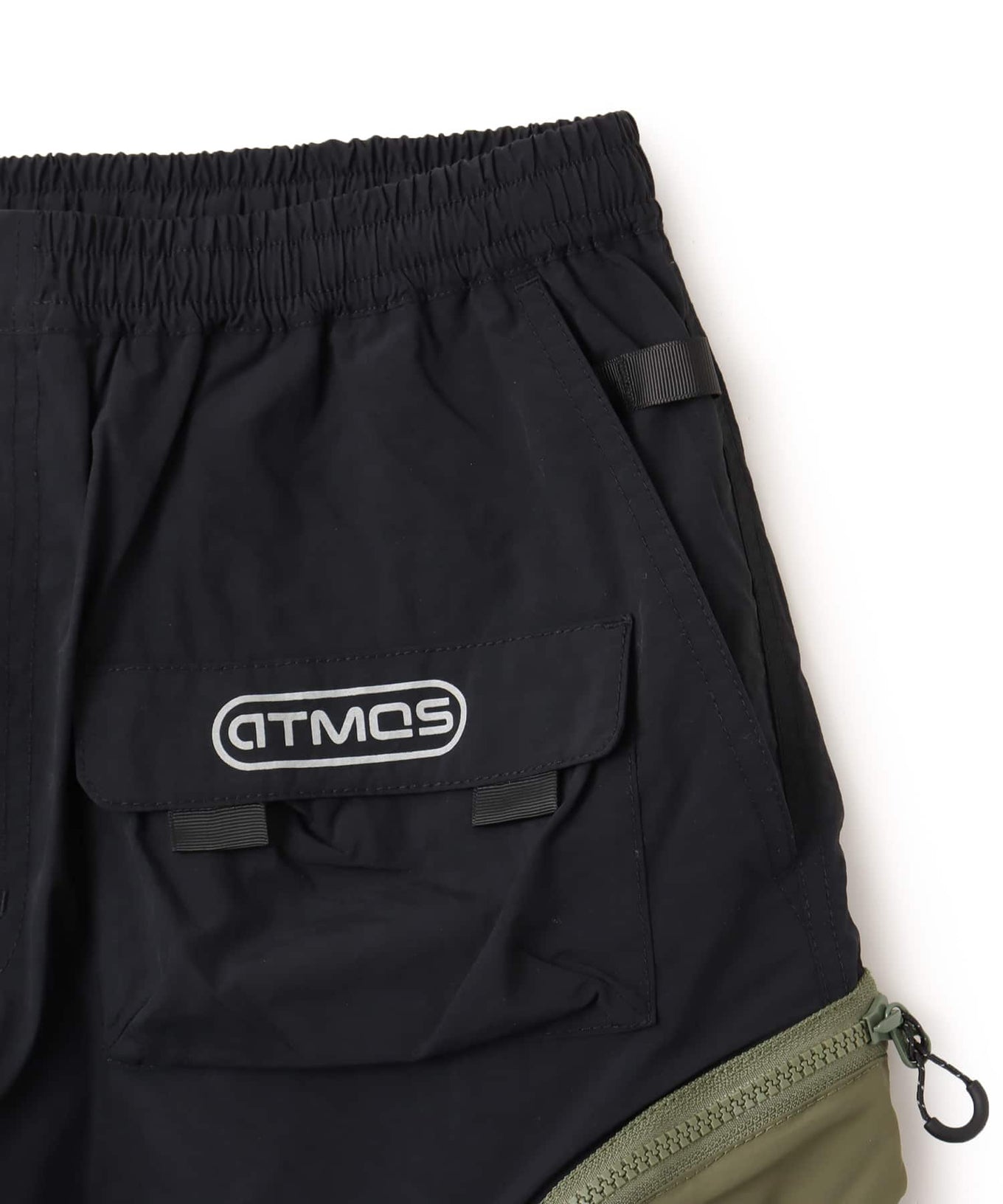 Model wearing functional cargo shorts with mesh and flap pockets in durable cotton fabric.