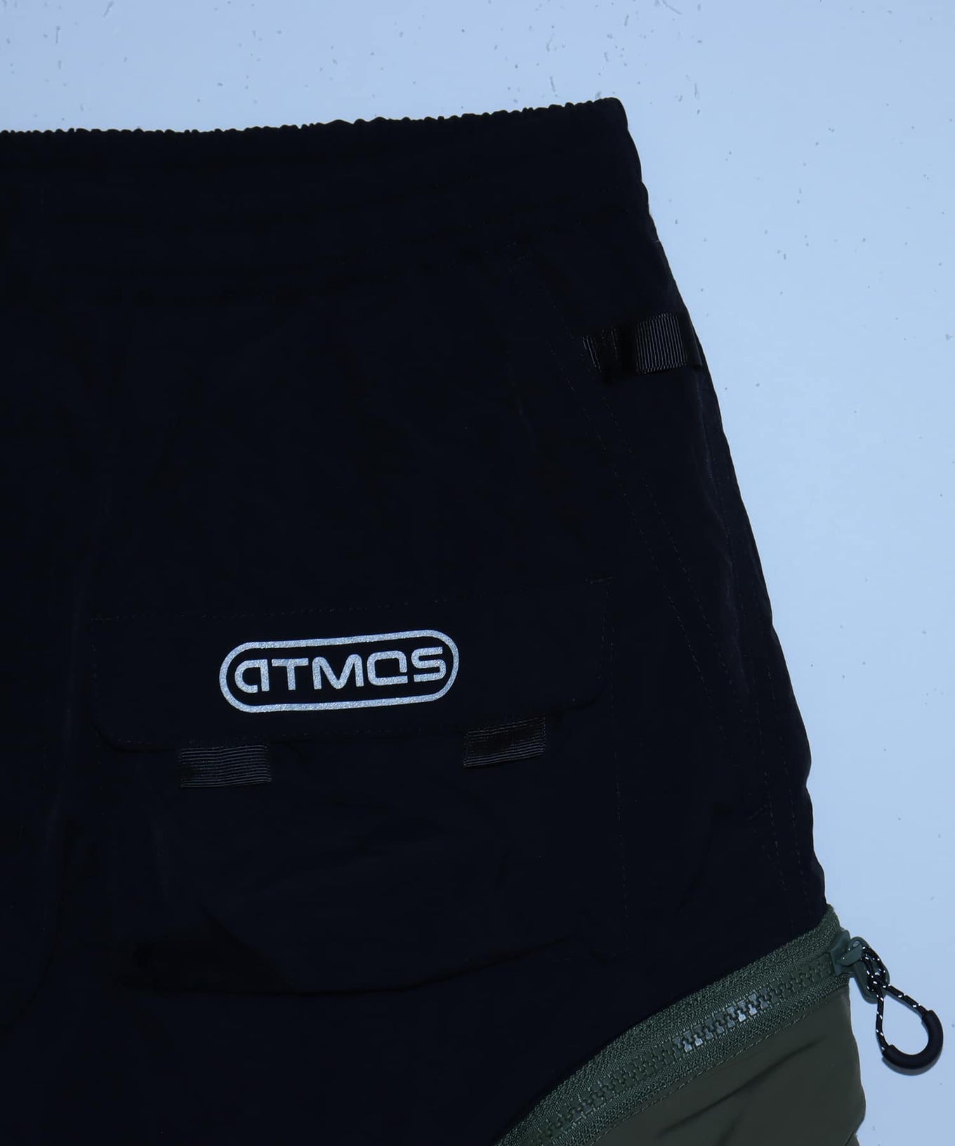 Model wearing functional cargo shorts with mesh and flap pockets in durable cotton fabric.