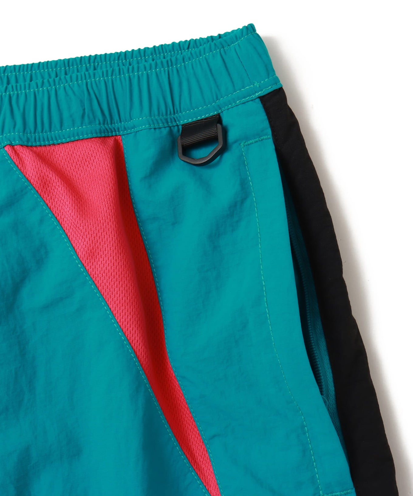 Wide-fit color-blocked nylon shorts with knee-length design and breathable mesh panels