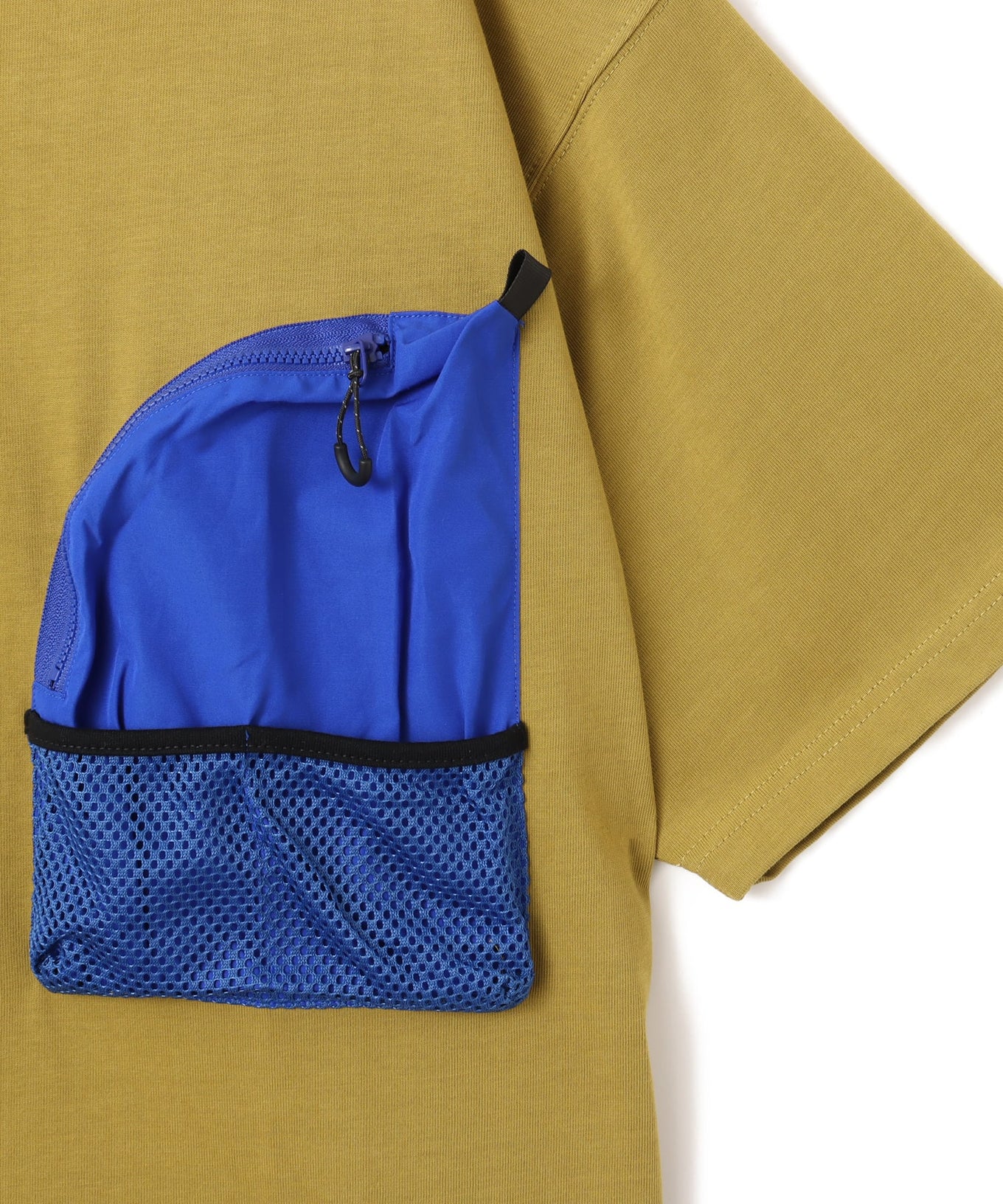 Model wearing a short-sleeved T-shirt with front zip pocket, made from textured, durable cotton.