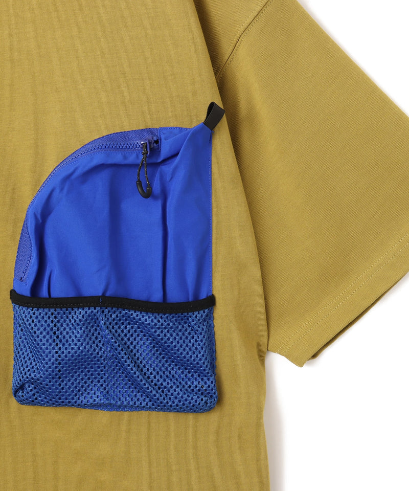 Model wearing a short-sleeved T-shirt with front zip pocket, made from textured, durable cotton.