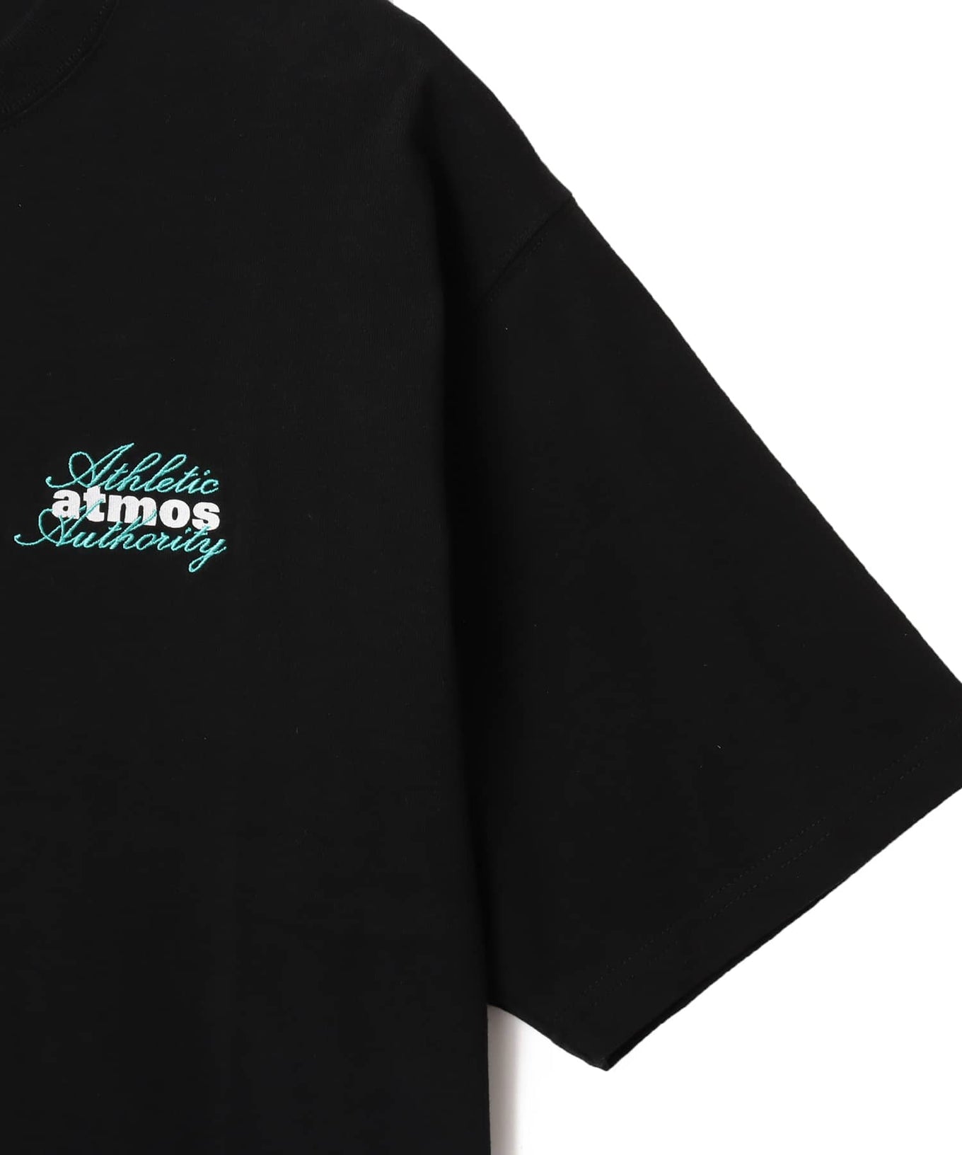 Model wearing short-sleeved atmos T-shirt with ATHENTIC AUTHORITY logo in embroidery and rubber print.