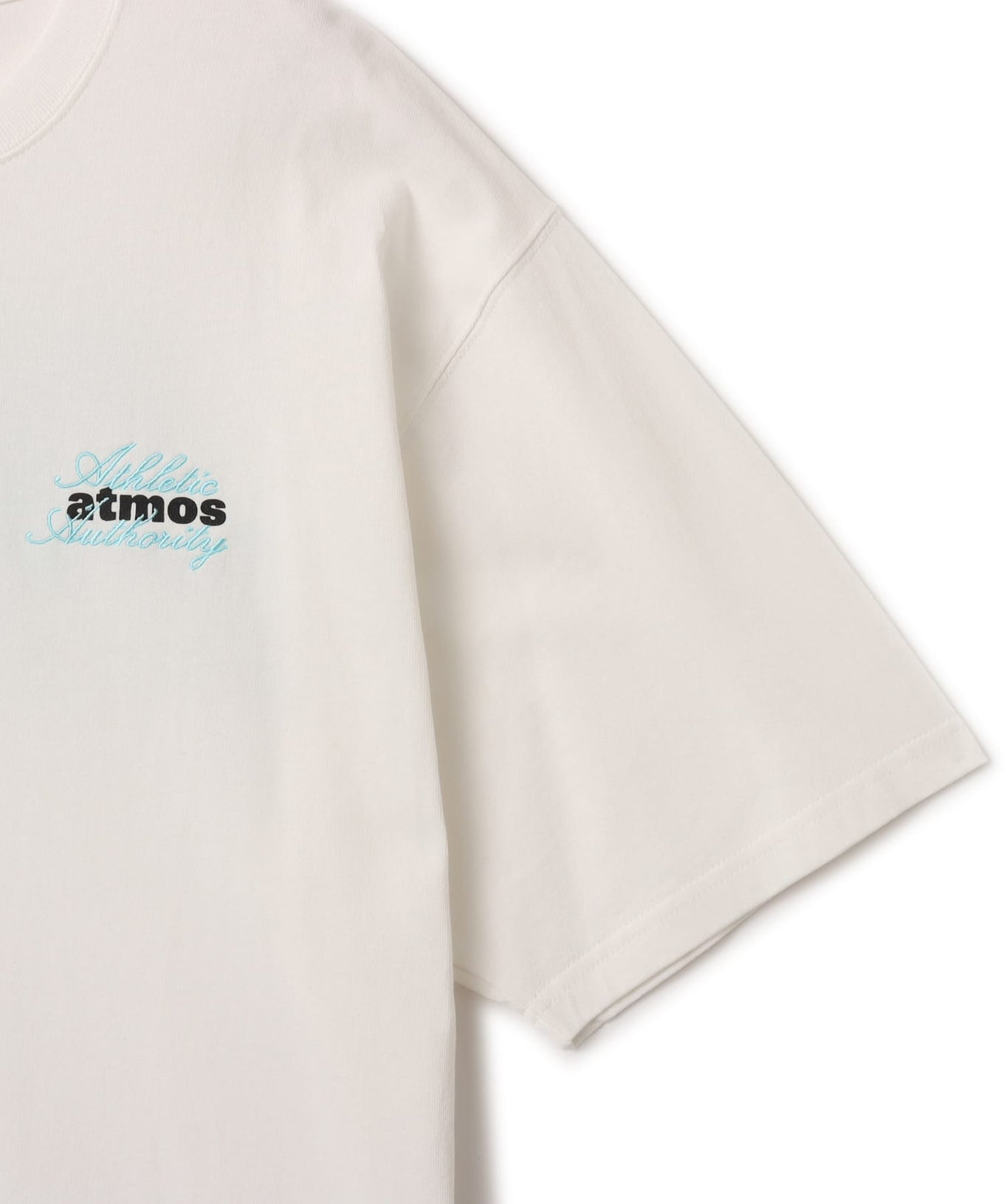 Model wearing short-sleeved atmos T-shirt with ATHENTIC AUTHORITY logo in embroidery and rubber print.