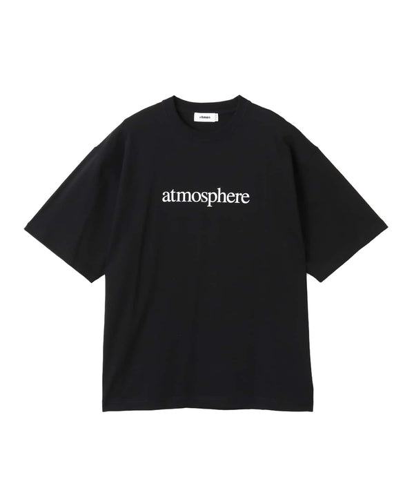 Model wearing a short-sleeved T-shirt with bold rubber-printed atmos logo on the front.