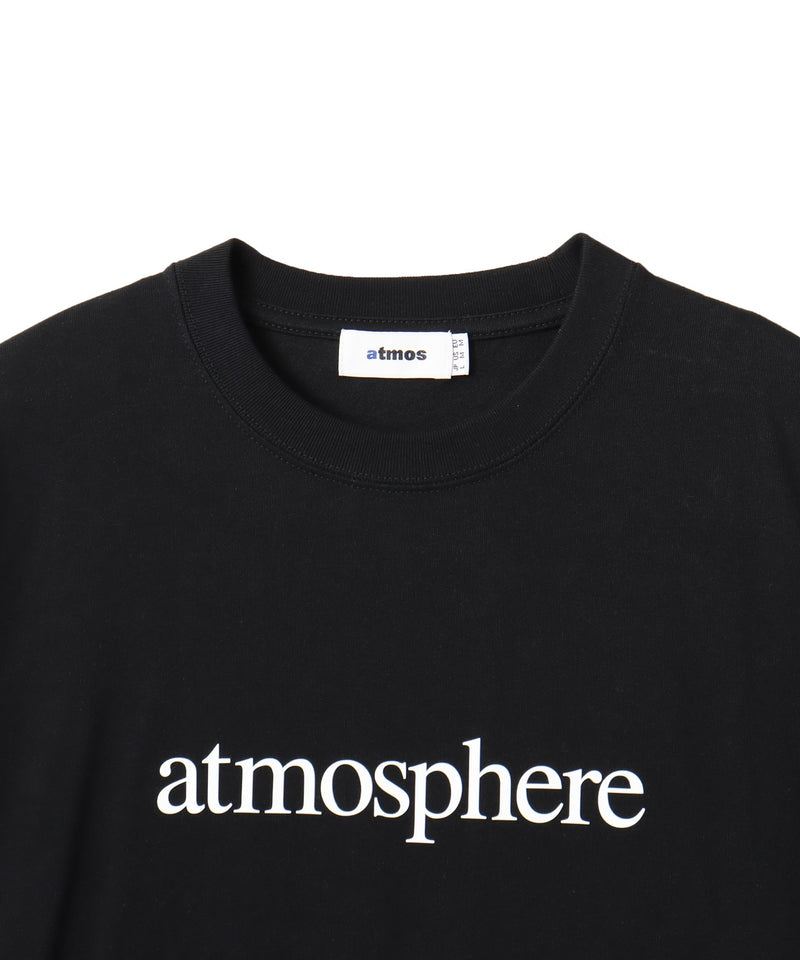 Model wearing a short-sleeved T-shirt with bold rubber-printed atmos logo on the front.