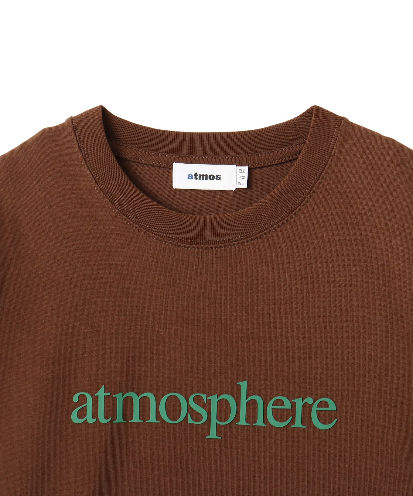 Model wearing a short-sleeved T-shirt with bold rubber-printed atmos logo on the front.