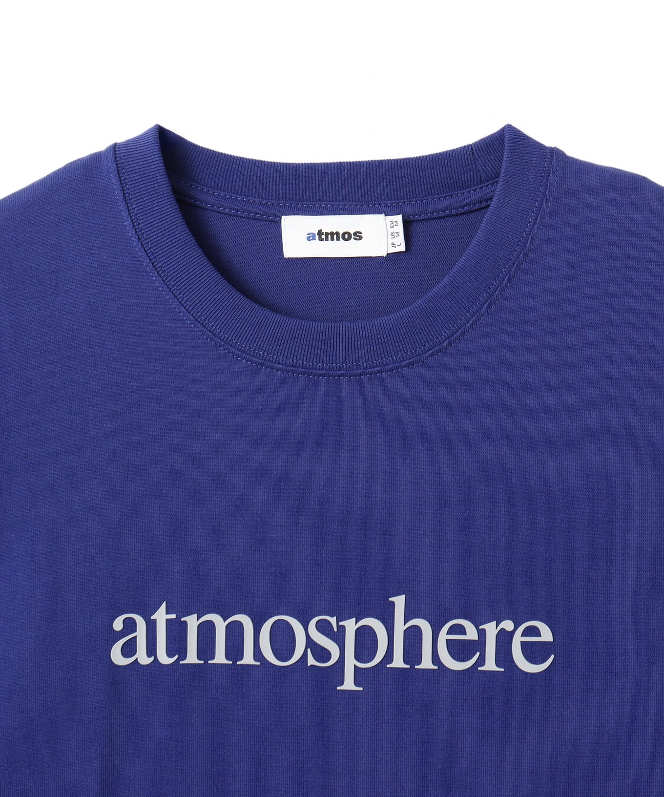 Model wearing a short-sleeved T-shirt with bold rubber-printed atmos logo on the front.