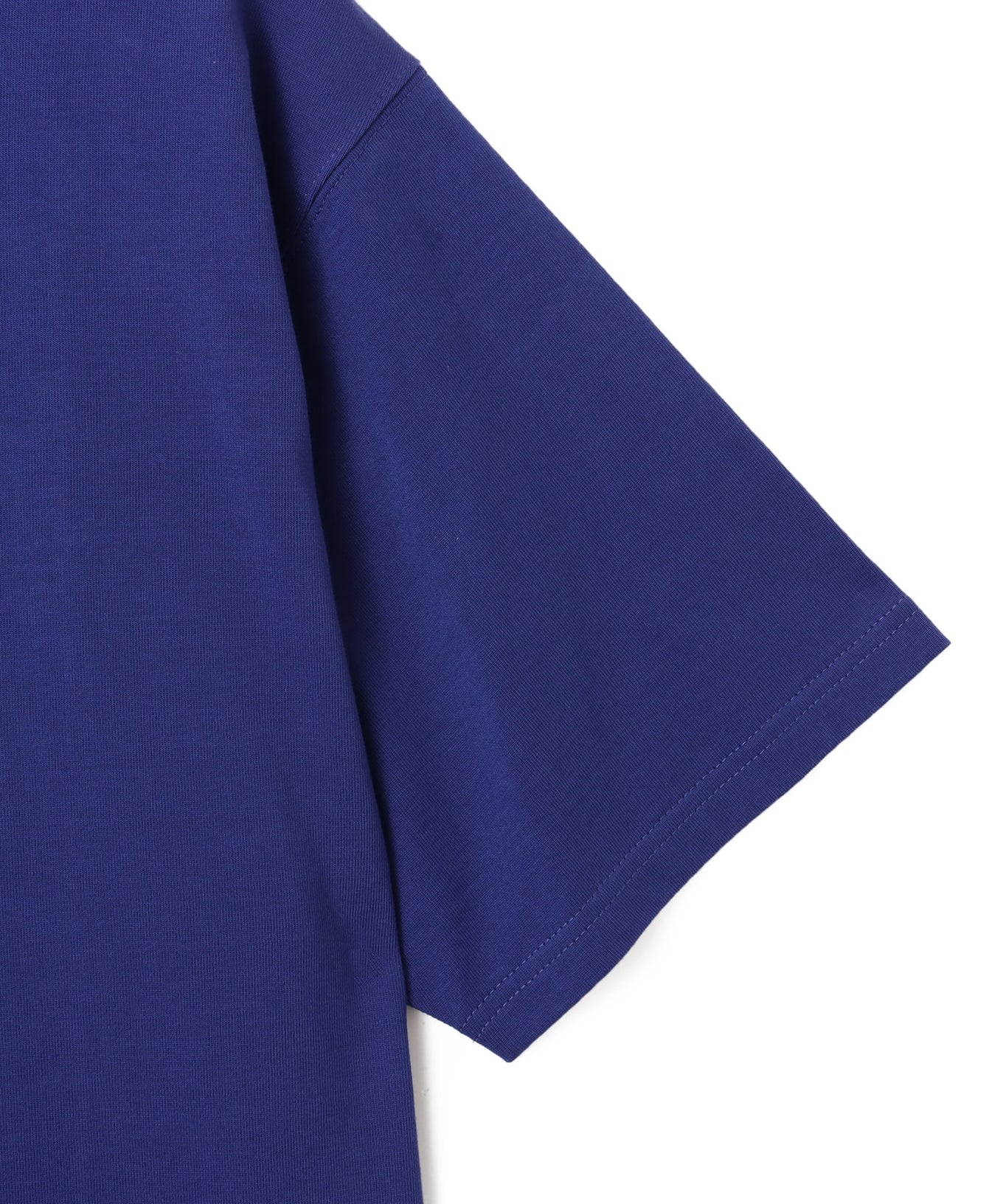 Model wearing a short-sleeved T-shirt with bold rubber-printed atmos logo on the front.