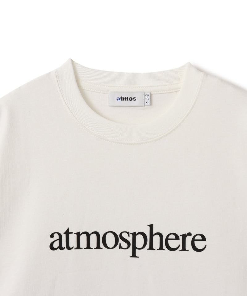 Model wearing a short-sleeved T-shirt with bold rubber-printed atmos logo on the front.