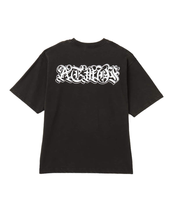 Black atmos T-shirt with Old English logo on front chest and back, styled with a vintage finish and worn by model.