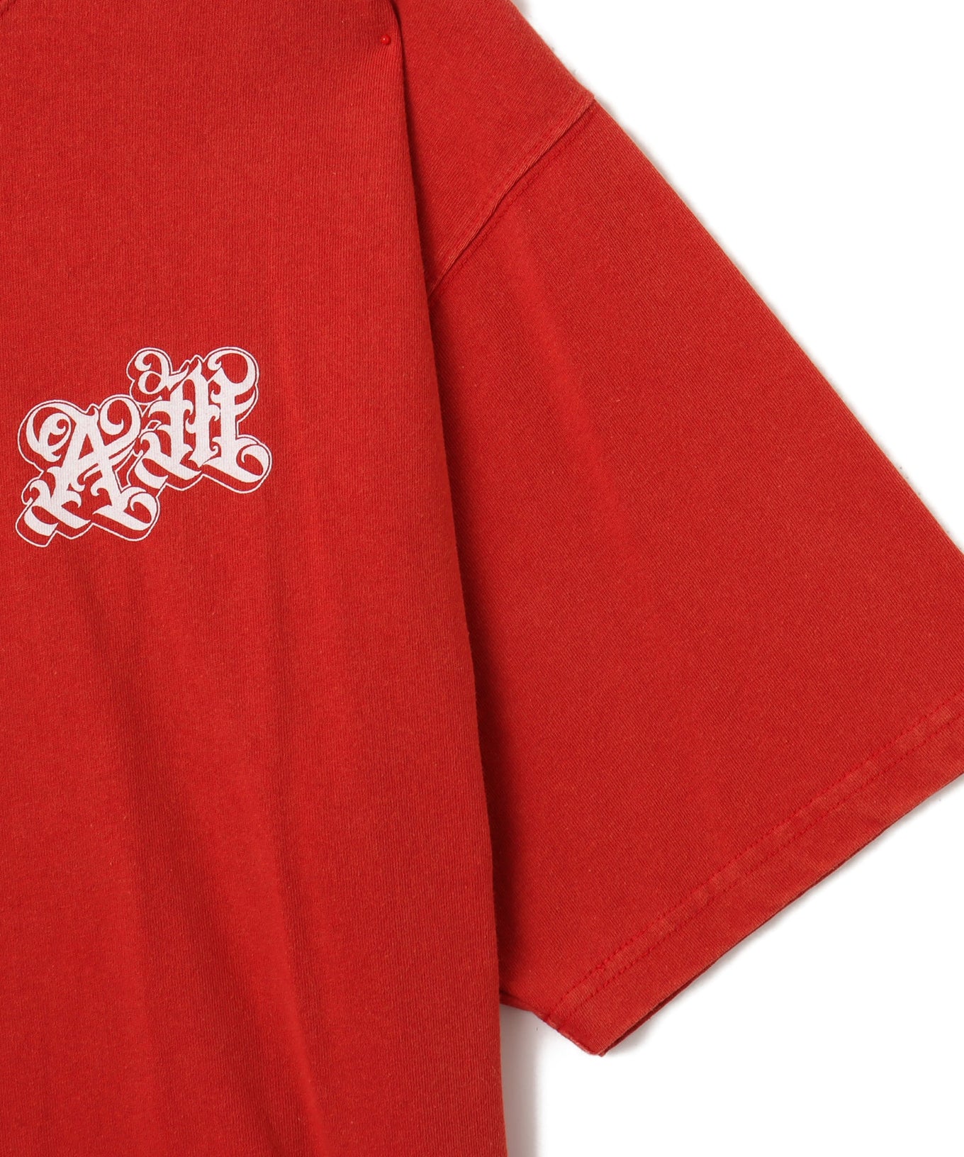 Black atmos T-shirt with Old English logo on front chest and back, styled with a vintage finish and worn by model.