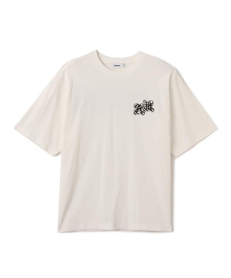 Black atmos T-shirt with Old English logo on front chest and back, styled with a vintage finish and worn by model.