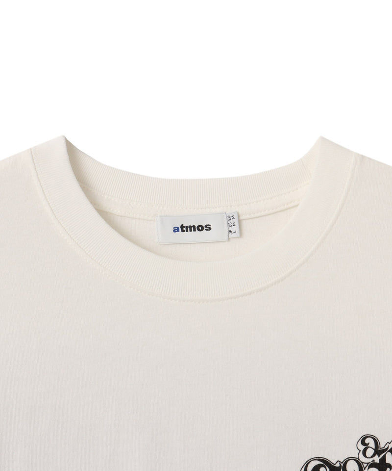 Black atmos T-shirt with Old English logo on front chest and back, styled with a vintage finish and worn by model.