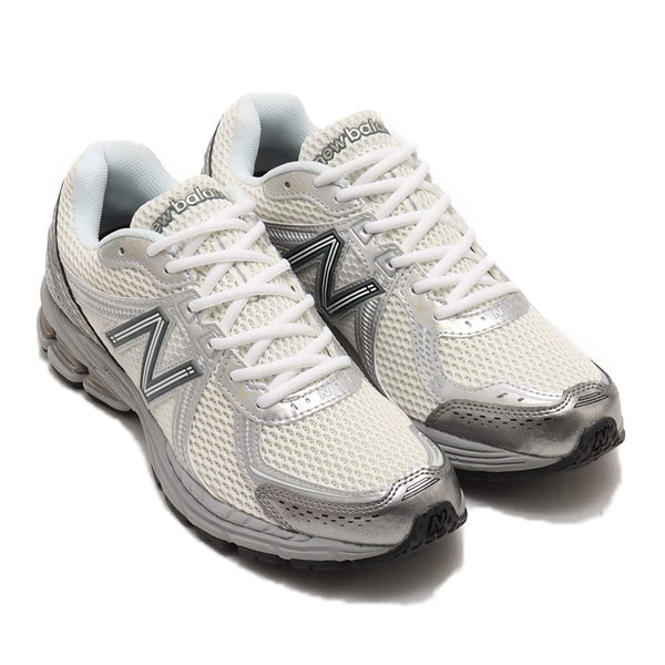 Futuristic sneakers with metallic silver synthetic upper, breathable air mesh, N-ERGY cushioning, ABZORB sole technology, and durable rubber outsole.