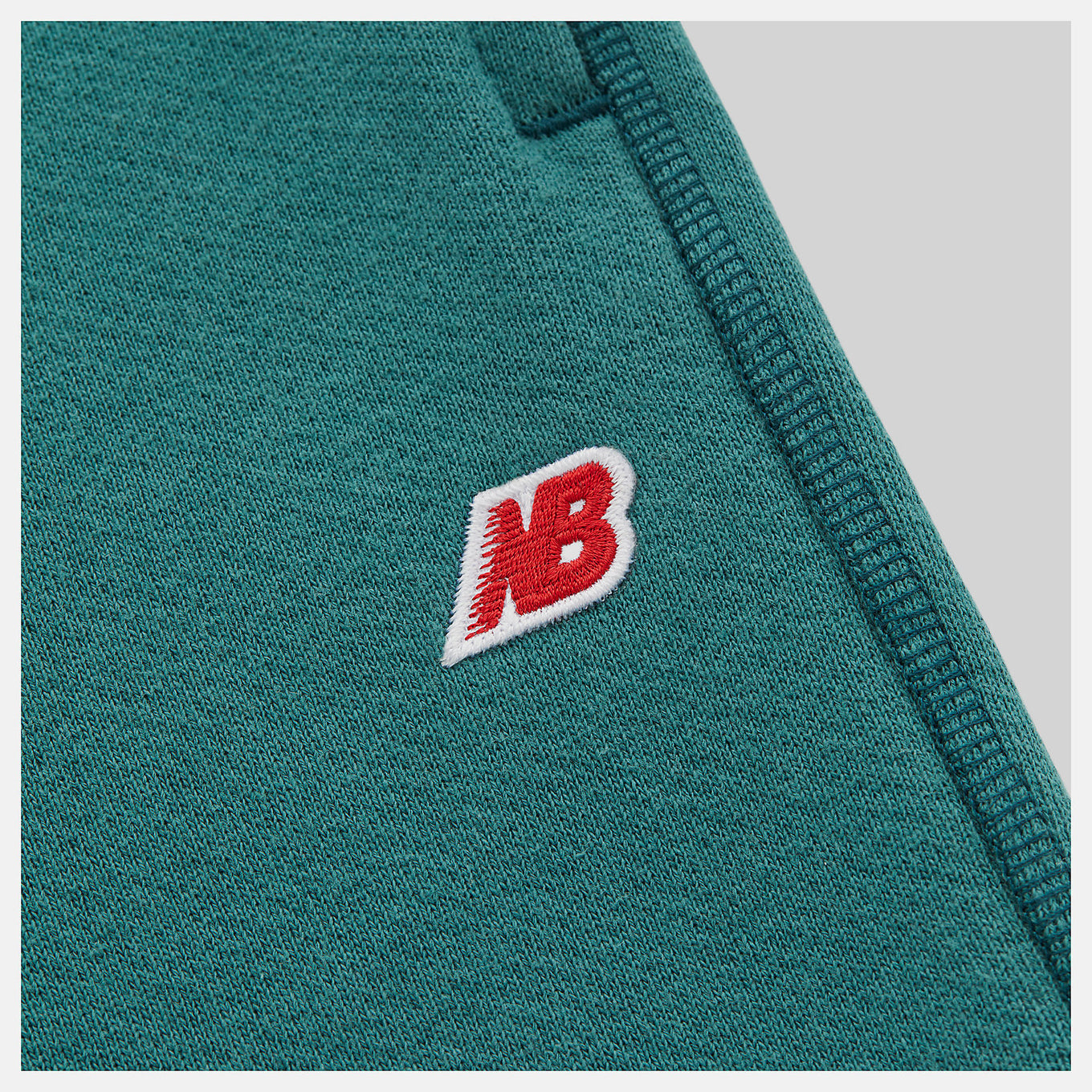 Made in USA Core Sweatpant in heavyweight French Terry, featuring a mid-rise cut, drawcord waistband, and embroidered patch logo, exemplifying timeless quality and craftsmanship.


