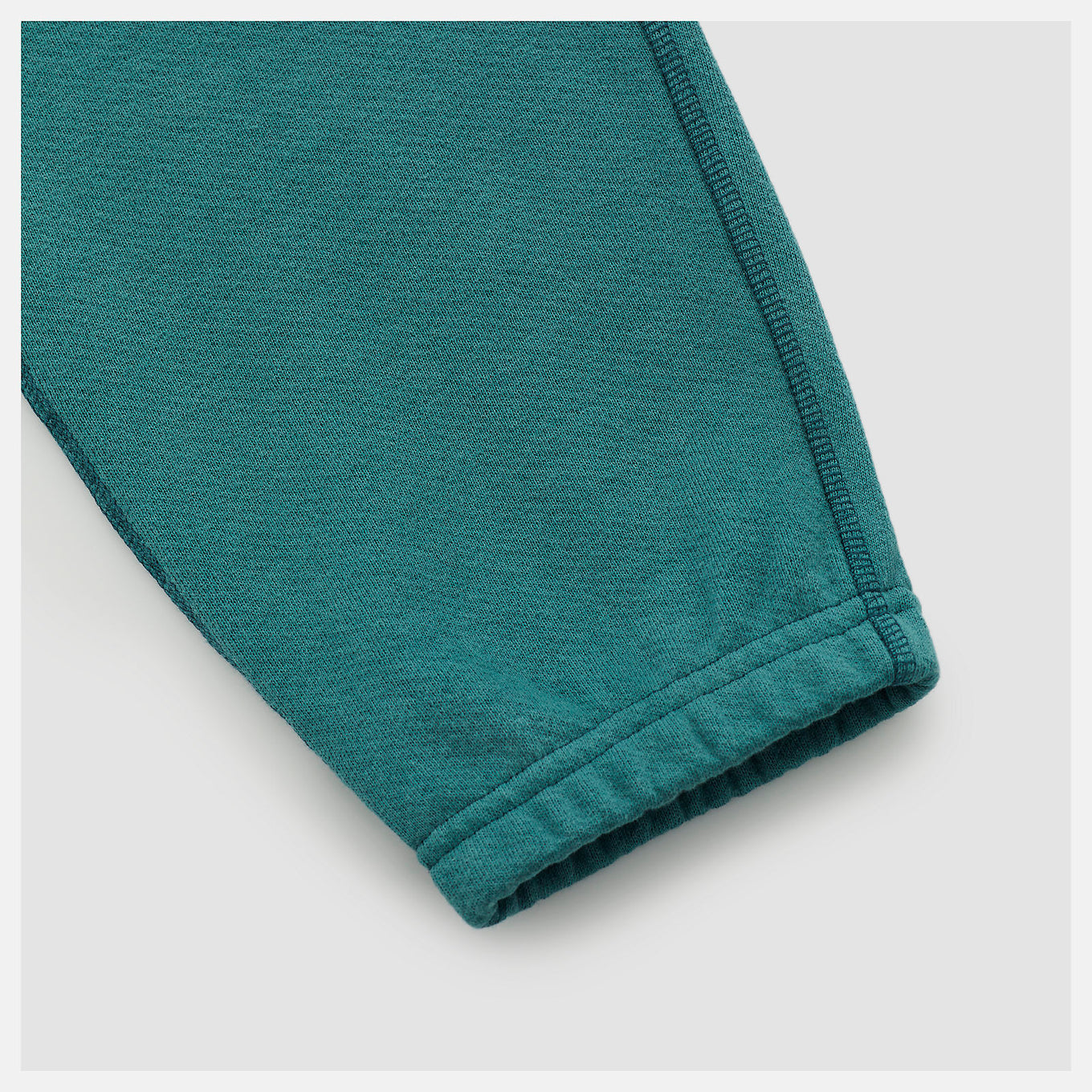 Made in USA Core Sweatpant in heavyweight French Terry, featuring a mid-rise cut, drawcord waistband, and embroidered patch logo, exemplifying timeless quality and craftsmanship.


