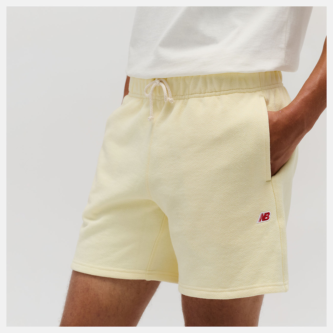 Close-up of the MADE in USA Core Short, showcasing its premium French Terry fabric, drawcord waistband, and embroidered patch logo.